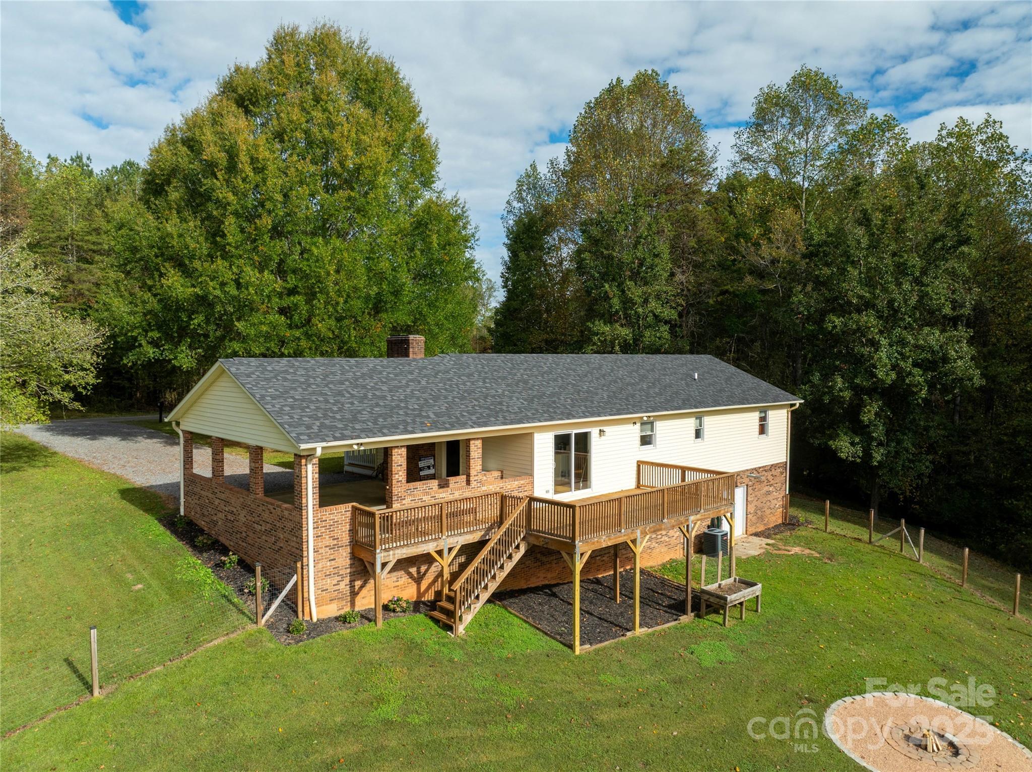 1627 Stony Knoll Road Dobson, NC 27017 - Photo 28 of 43 a aerial view of a house with a yard table and chairs