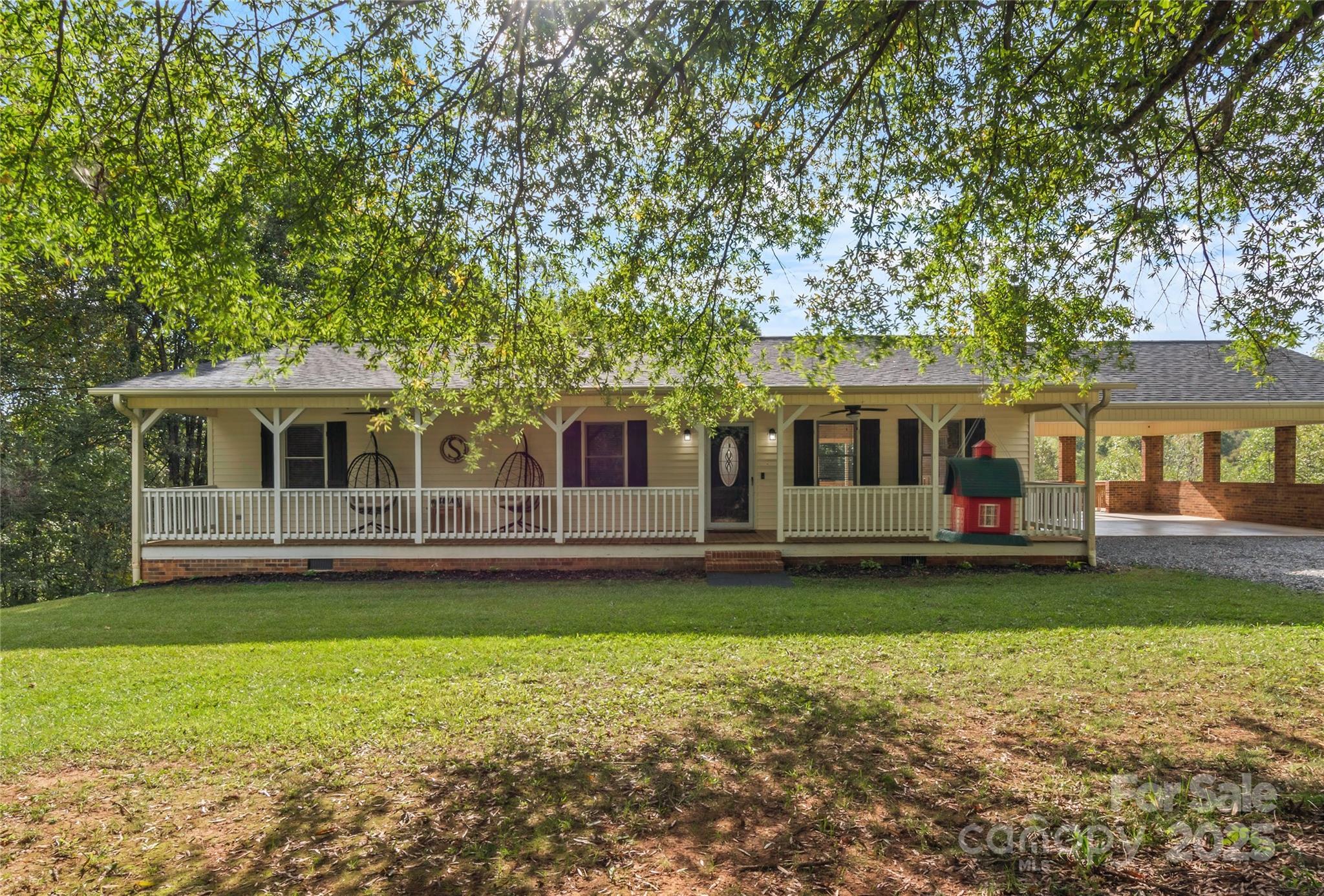 1627 Stony Knoll Road Dobson, NC 27017 - Photo 5 of 43 a front view of a house with a garden and swimming pool