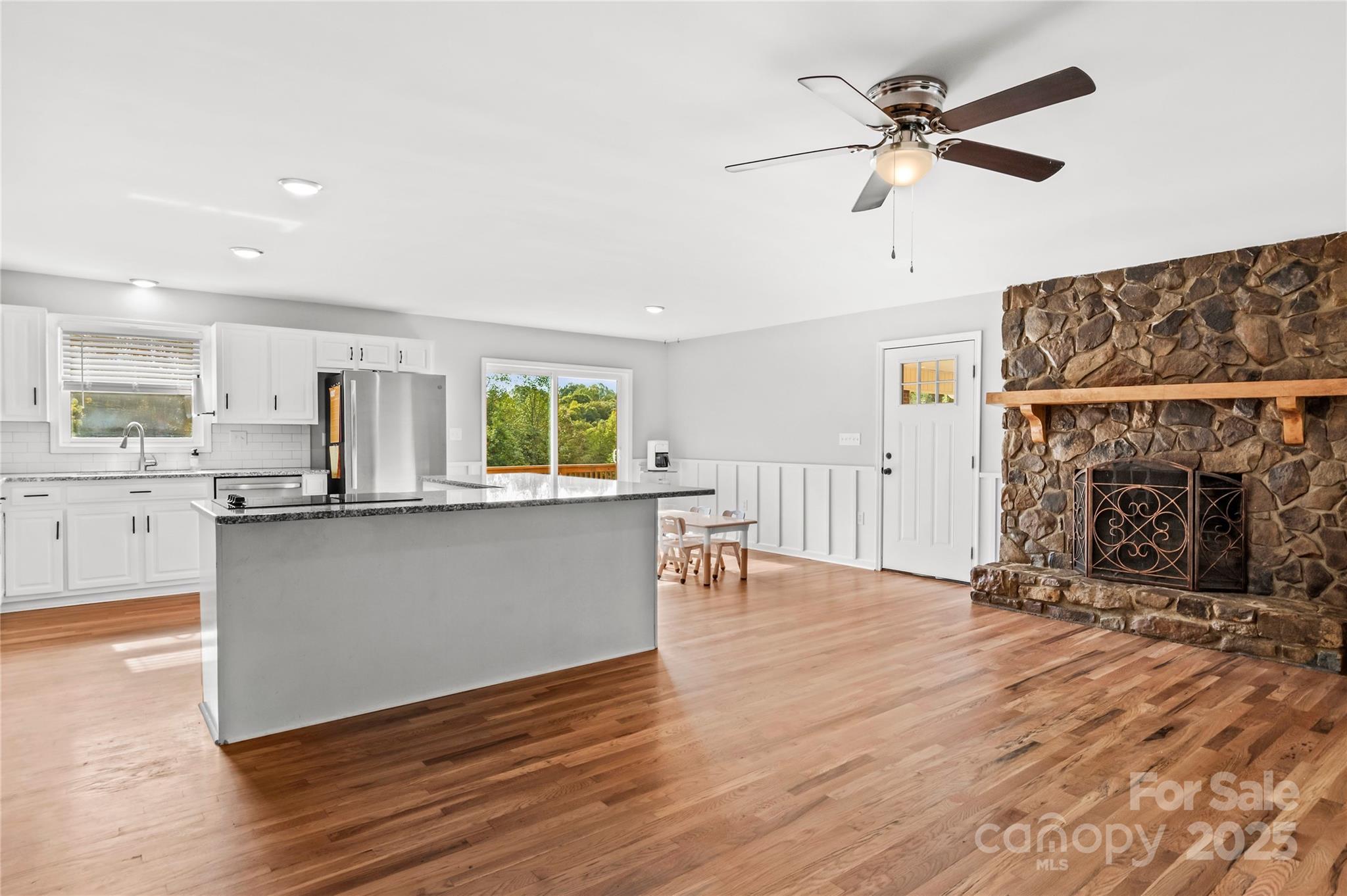 1627 Stony Knoll Road Dobson, NC 27017 - Photo 8 of 43 a living room with stainless steel appliances kitchen island a fireplace and wooden floor