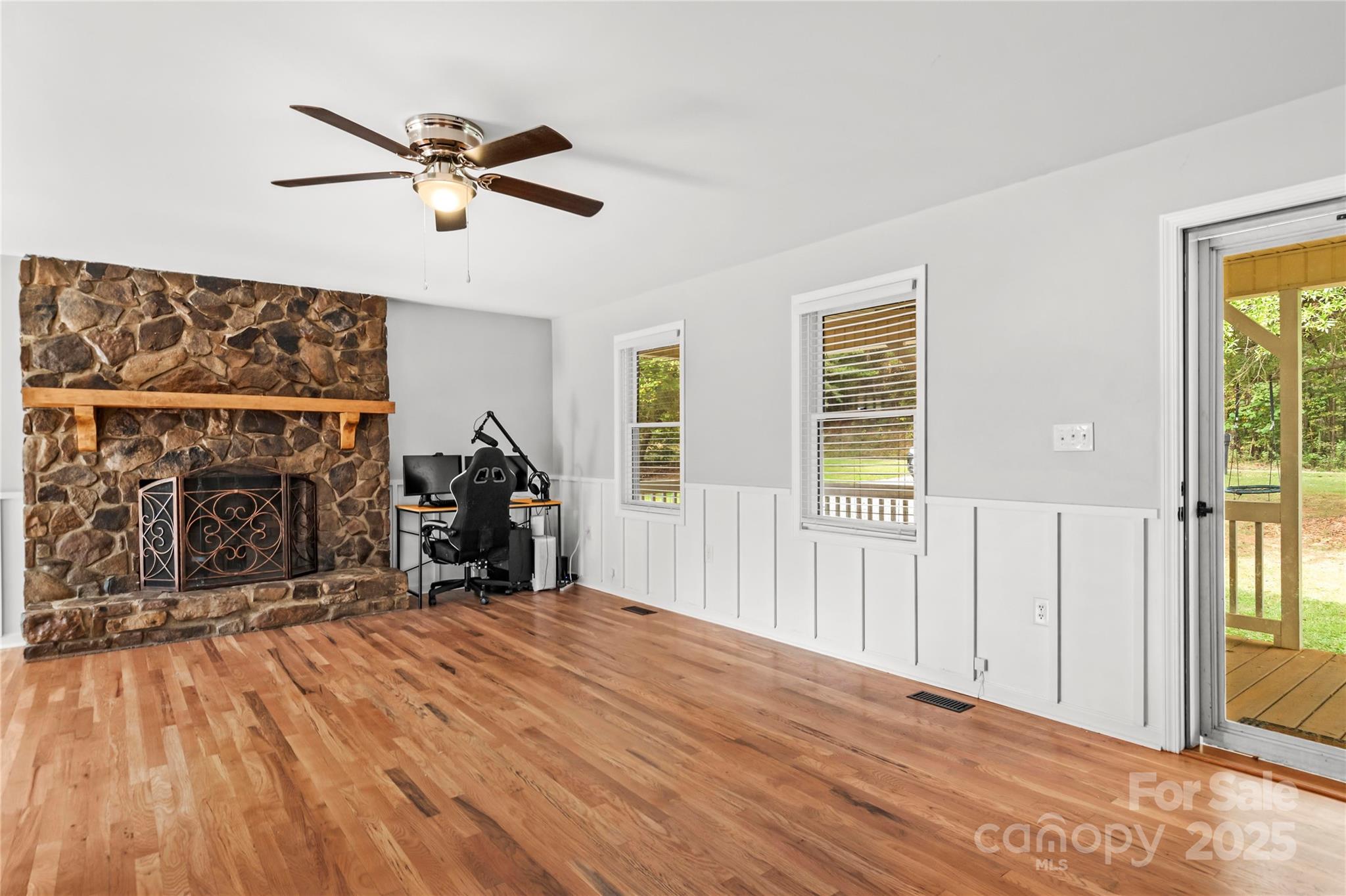 1627 Stony Knoll Road Dobson, NC 27017 - Photo 9 of 43 a view of a livingroom with wooden floor and a ceiling fan
