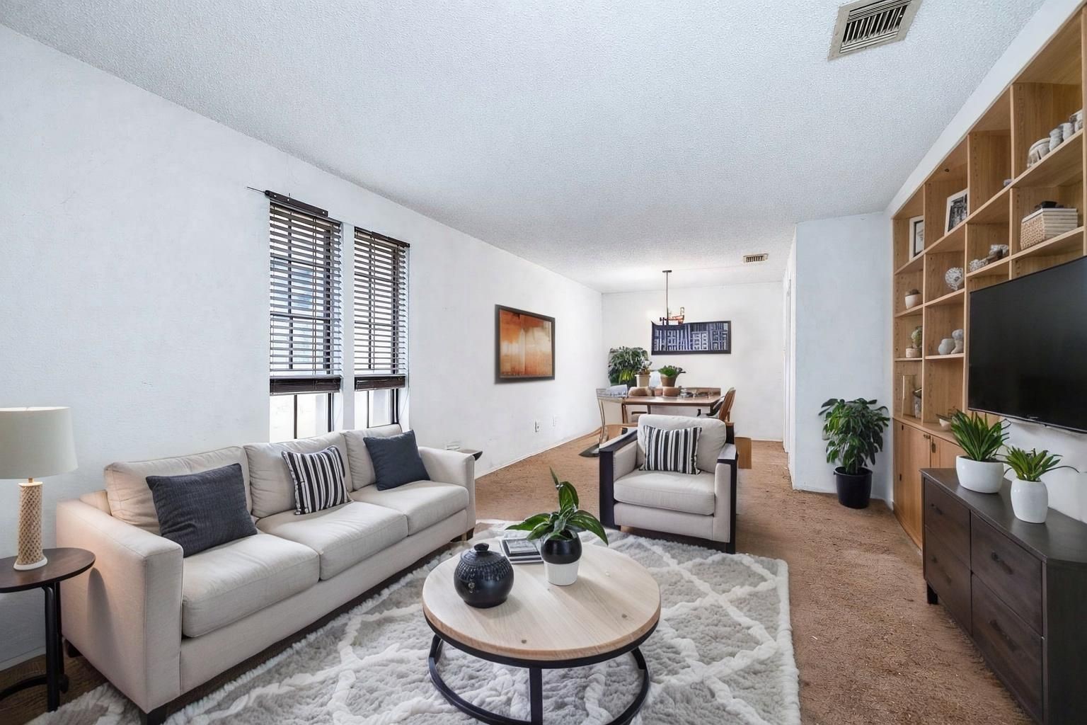 12703 Redfern Drive Houston, TX 77048 - Photo 3 of 15 a living room with furniture a flat screen tv and a window