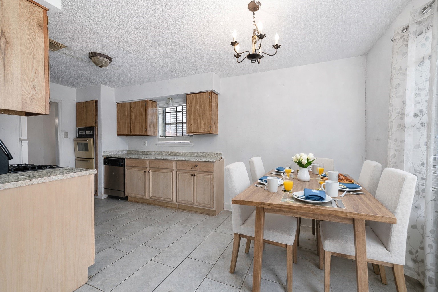 12703 Redfern Drive Houston, TX 77048 - Photo 5 of 15 a kitchen with stainless steel appliances kitchen island granite countertop a dining table chairs and a refrigerator