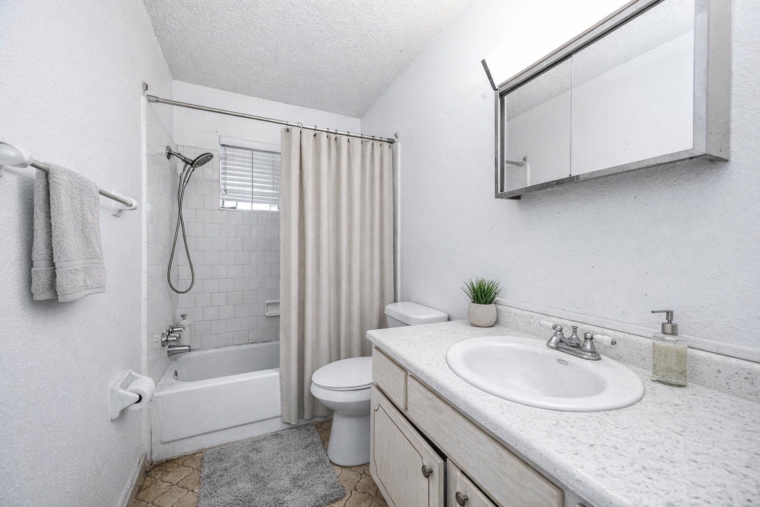 12703 Redfern Drive Houston, TX 77048 - Photo 10 of 15 a bathroom with a granite countertop sink a toilet and bathtub