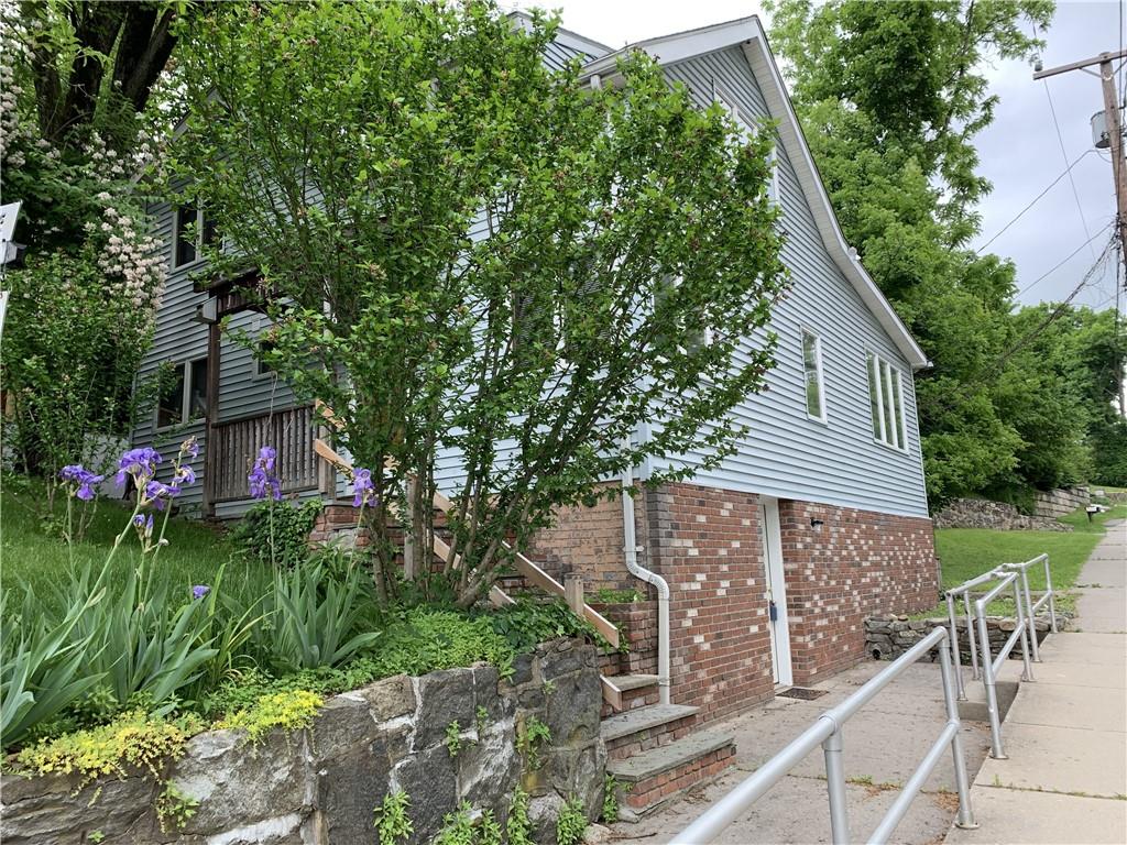 a view of a house with a yard and sitting area