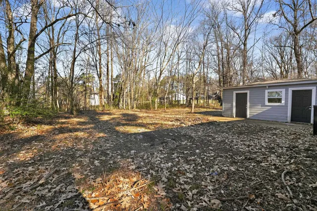 a view of a house with a large tree