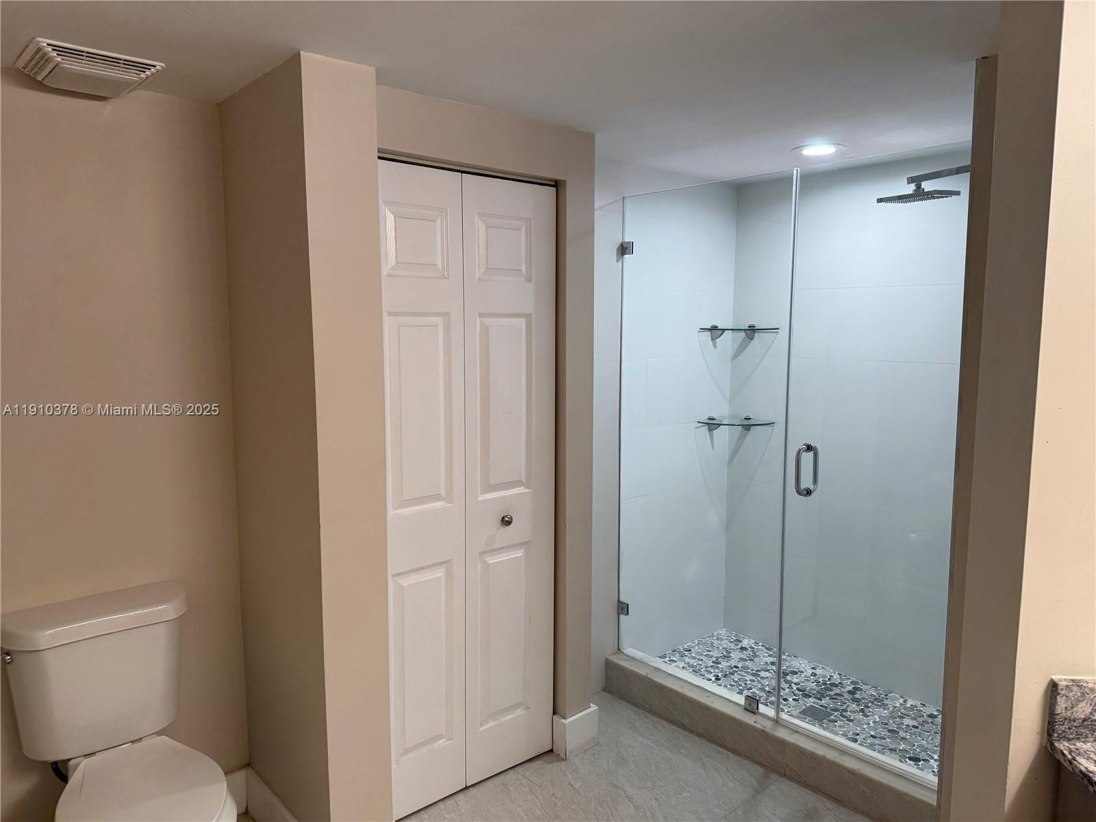 17150 North Bay Road, Unit 2102 Sunny Isles Beach, FL 33160 - Photo 13 of 29 a bathroom with a shower a toilet and a sink