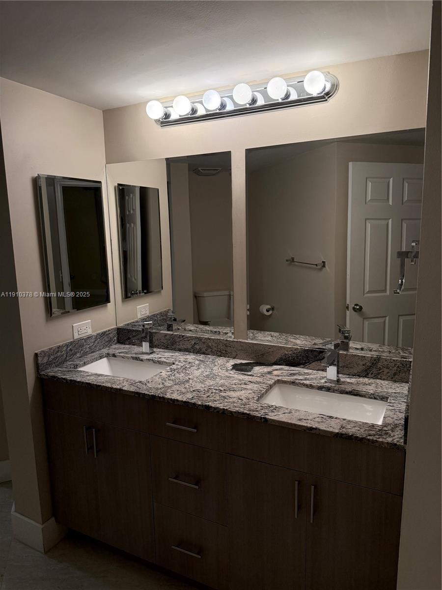 17150 North Bay Road, Unit 2102 Sunny Isles Beach, FL 33160 - Photo 14 of 29 a bathroom with double sink and a mirror