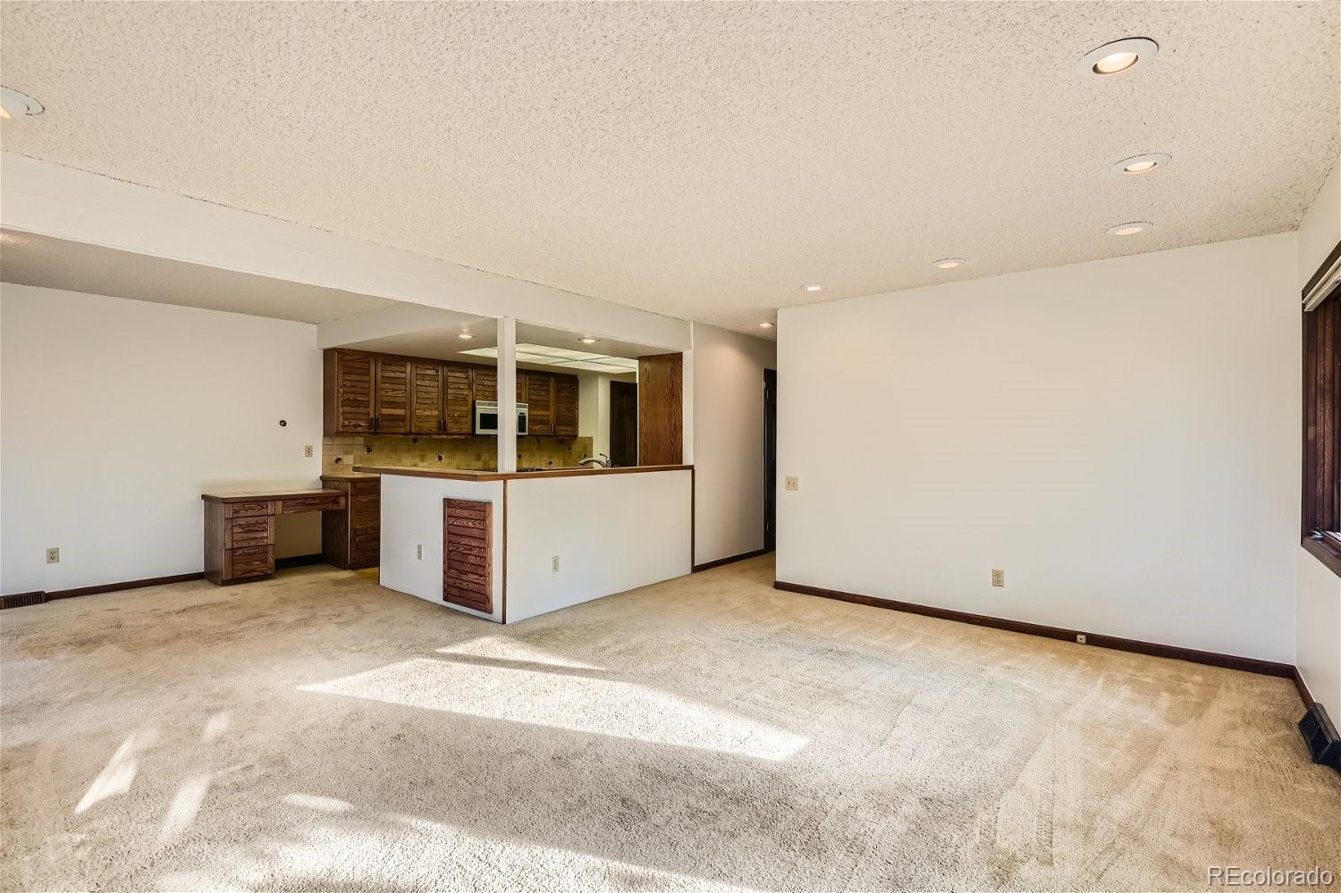 3398 East Easter Place Centennial, CO 80122 - Photo 11 of 28 a view of an empty room with a kitchen