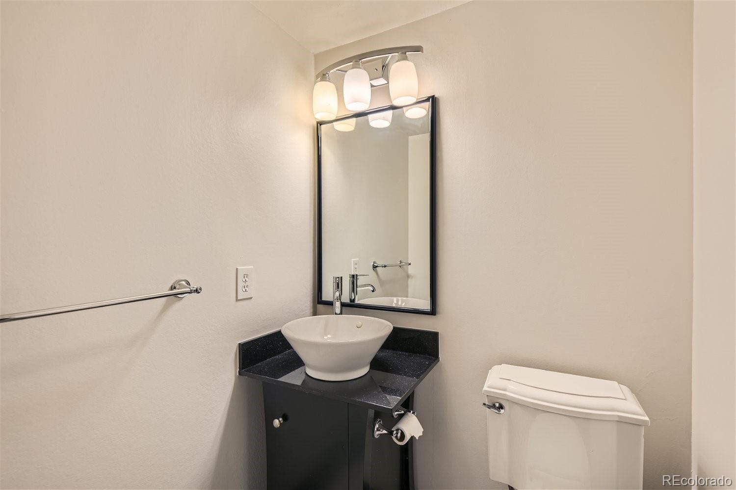 3398 East Easter Place Centennial, CO 80122 - Photo 12 of 28 a bathroom with a sink a toilet and mirror