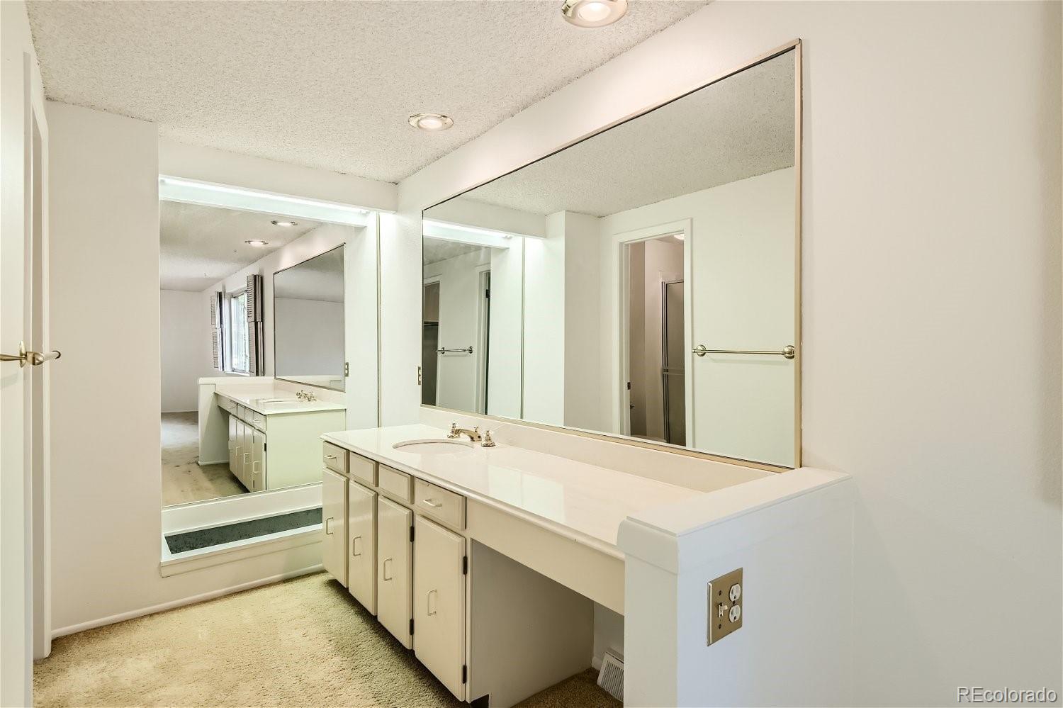 3398 East Easter Place Centennial, CO 80122 - Photo 16 of 28 a bathroom with a double vanity sink and mirror