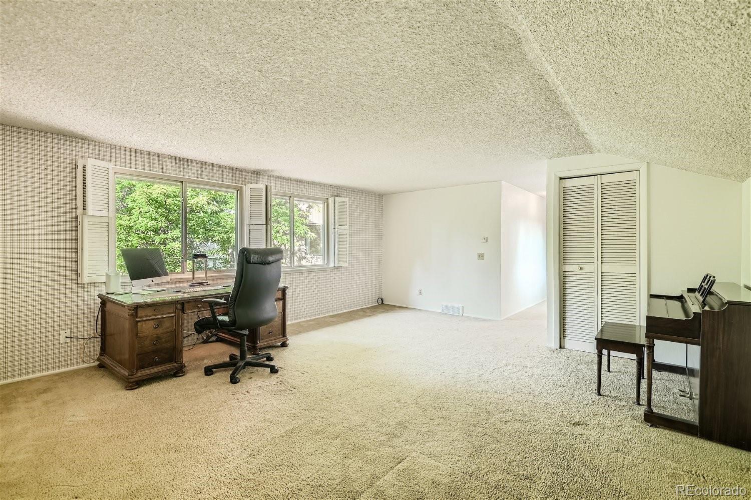 3398 East Easter Place Centennial, CO 80122 - Photo 18 of 28 a view of a workspace with furniture and a window
