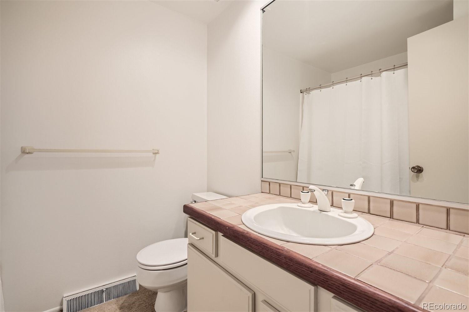 3398 East Easter Place Centennial, CO 80122 - Photo 20 of 28 a bathroom with a granite countertop sink and a mirror