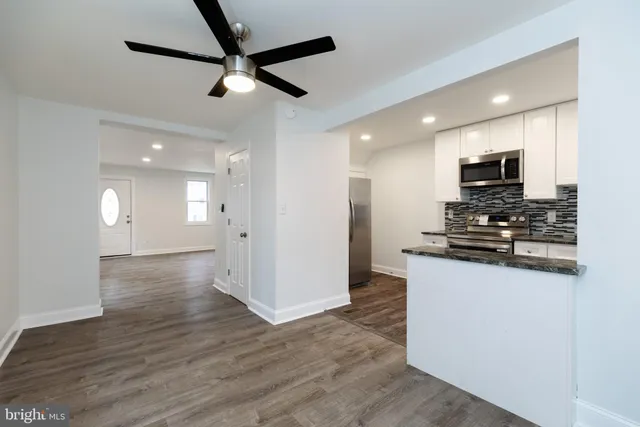 a view of kitchen with sink microwave and refrigerator