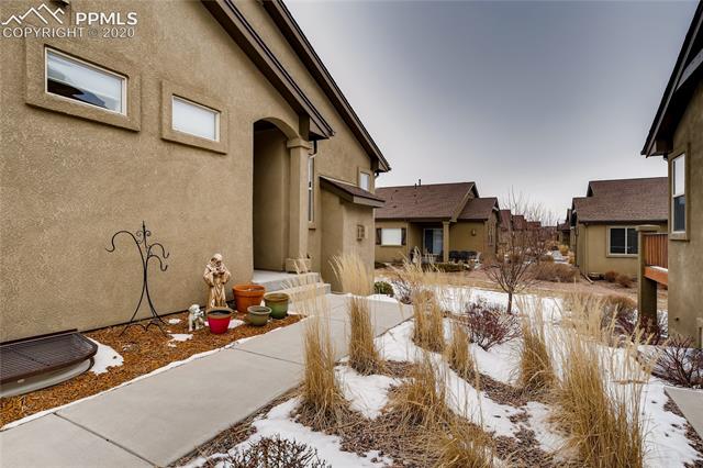 7676 Wichita Ridge Point Colorado Springs, CO 80923 - Photo 2 of 34 Stucco exterior with detailed landscaping