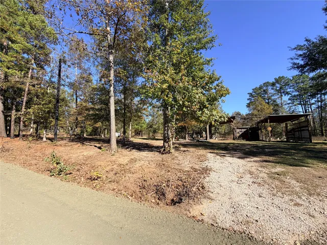 a view of a yard covered with snow in front of house