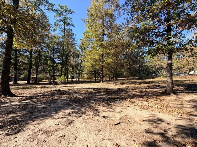 a view of a backyard with table and chairs and a fire pit