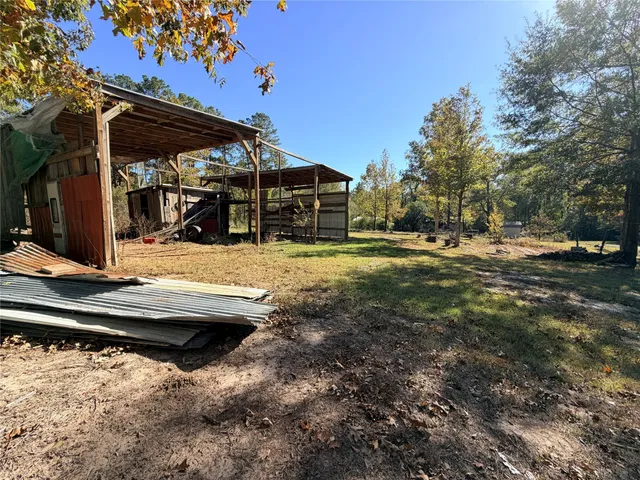 a view of a yard with wooden fence