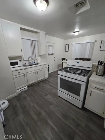a kitchen with stainless steel appliances a stove a sink and a refrigerator
