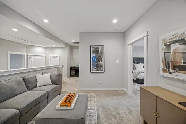 a living room with furniture and painting on the wall
