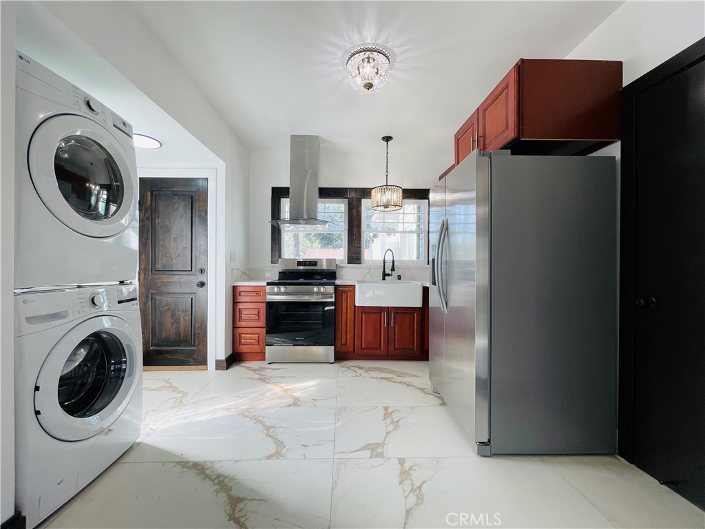 3225 Locust Street Riverside, CA 92501 - Photo 18 of 63 a kitchen with stainless steel appliances a refrigerator a washer and dryer