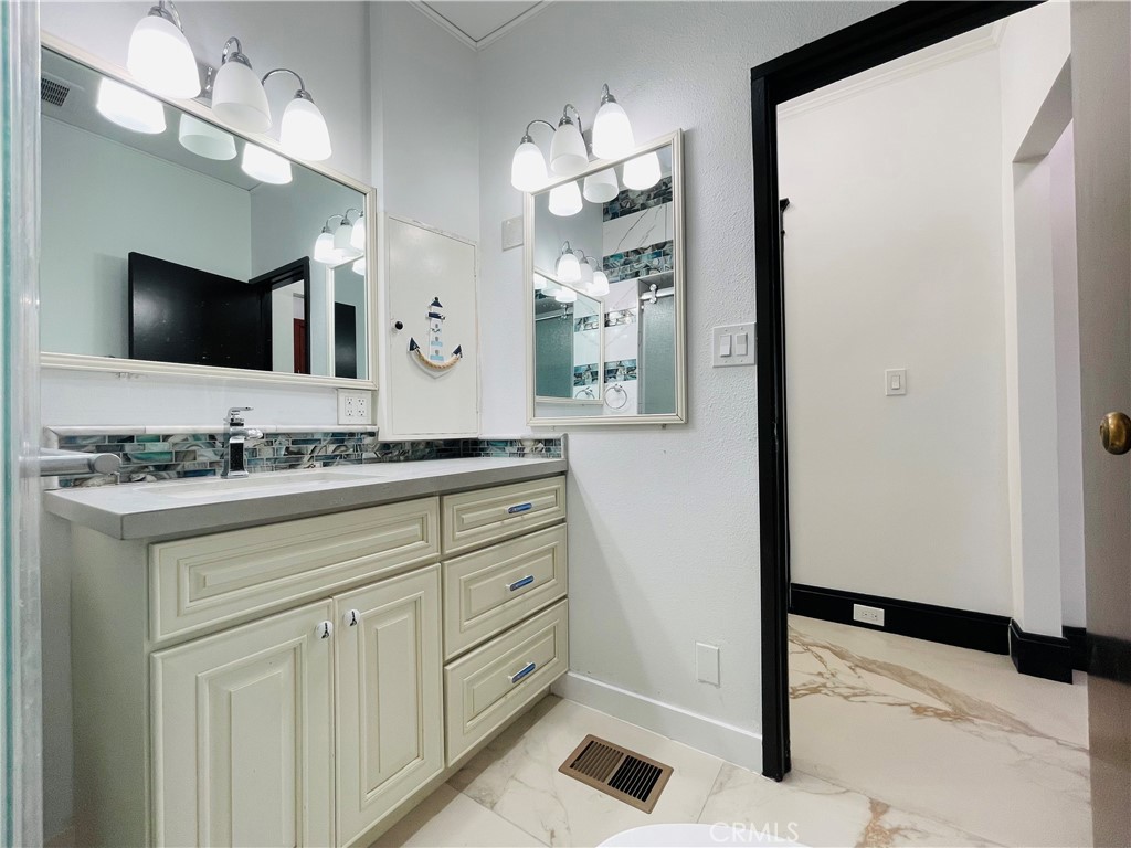 3225 Locust Street Riverside, CA 92501 - Photo 34 of 63 a bathroom with a sink and a mirror