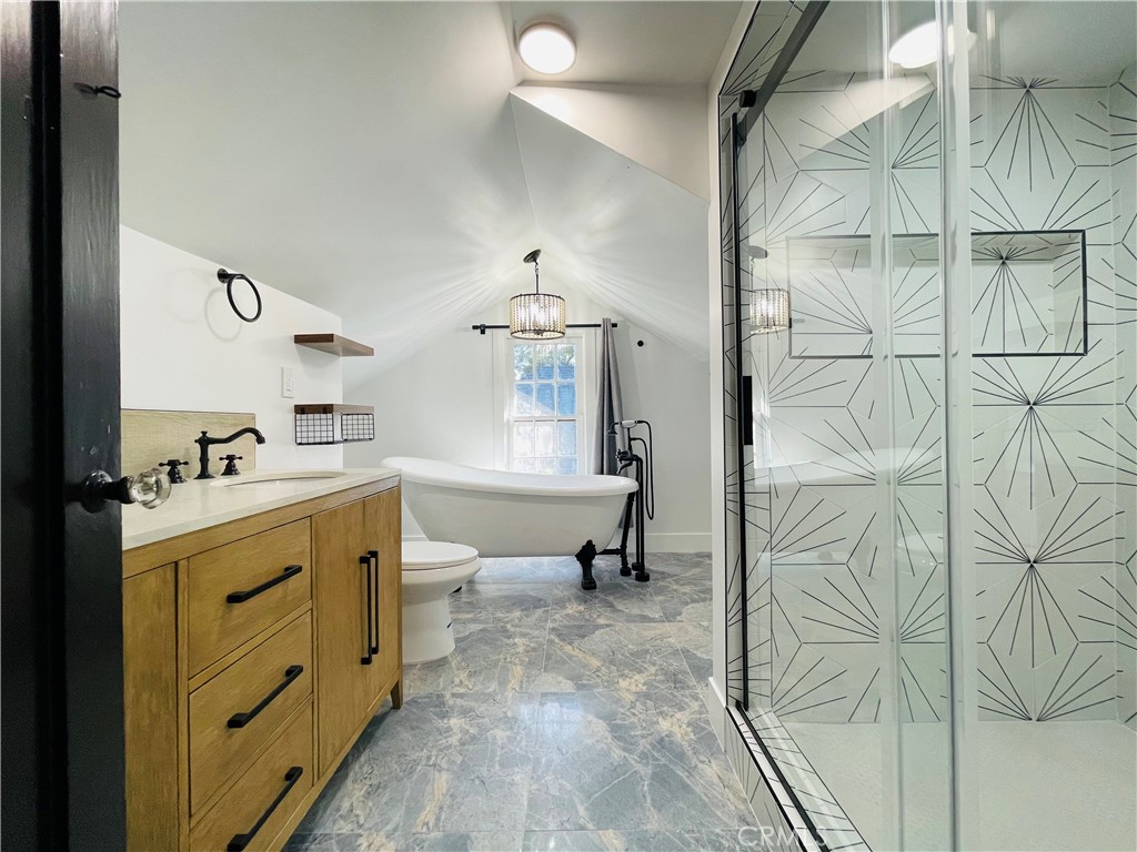 3225 Locust Street Riverside, CA 92501 - Photo 45 of 63 a spacious bathroom with a double vanity sink and a mirror