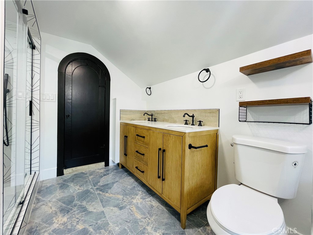 3225 Locust Street Riverside, CA 92501 - Photo 47 of 63 a bathroom with a toilet sink vanity and mirror
