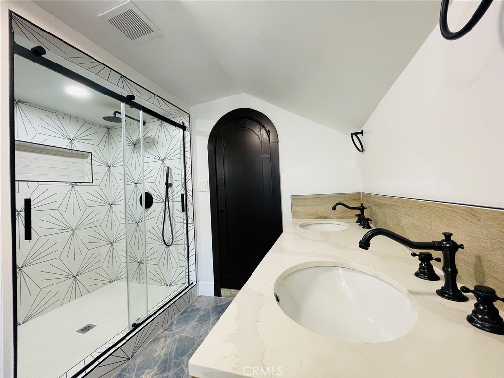 3225 Locust Street Riverside, CA 92501 - Photo 48 of 63 a bathroom with a sink and glass door shower