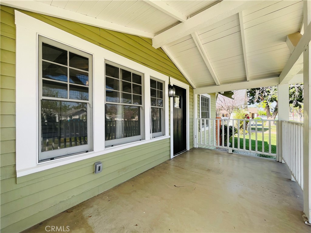 3225 Locust Street Riverside, CA 92501 - Photo 5 of 63 a view of a porch with a floor to ceiling window and plants