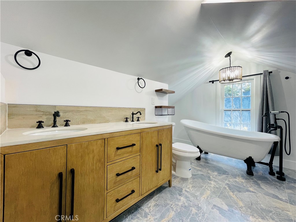 3225 Locust Street Riverside, CA 92501 - Photo 51 of 63 a spacious bathroom with a tub sink and mirror