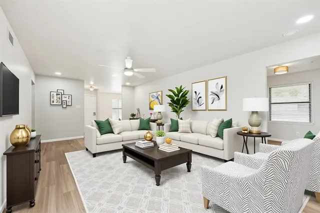 a living room with furniture and wooden floor