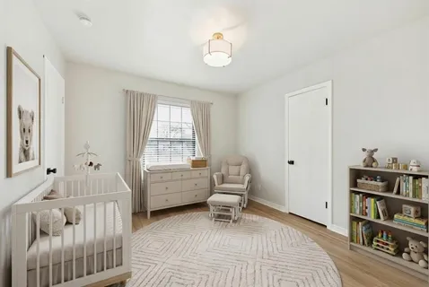 an empty room with wooden floor ceiling fan and windows