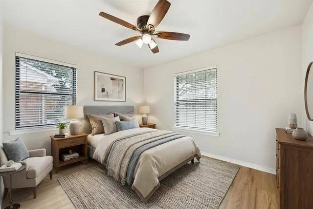 a bedroom with a bed couch and a window
