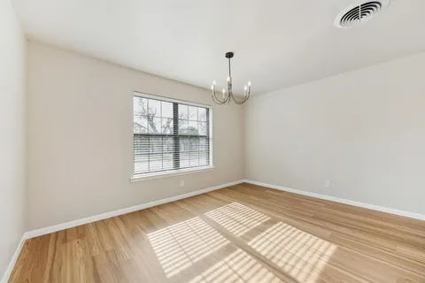 a view of an empty room and wooden floor
