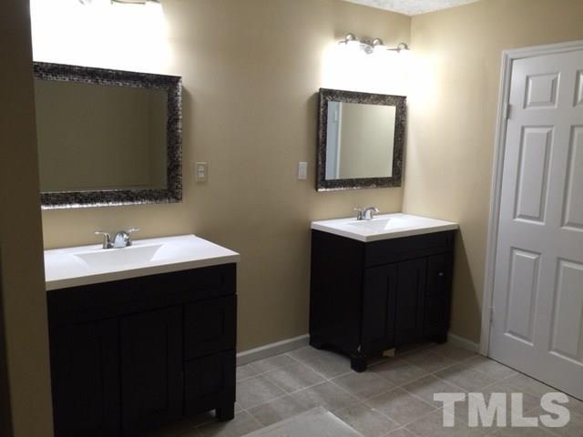5109 Dice Drive Raleigh, NC 27616 - Photo 15 of 22 a bathroom with a sink and a mirror