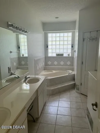 a bathroom with a granite countertop sink a toilet and bathtub