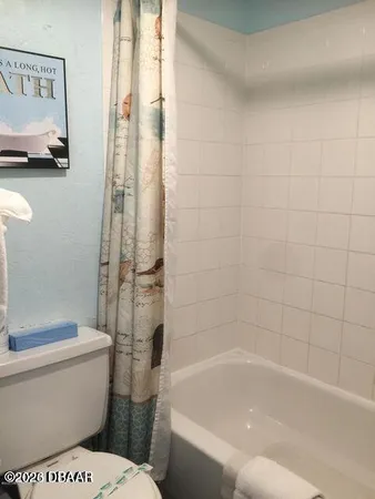 a bathroom with a granite countertop toilet sink and shower
