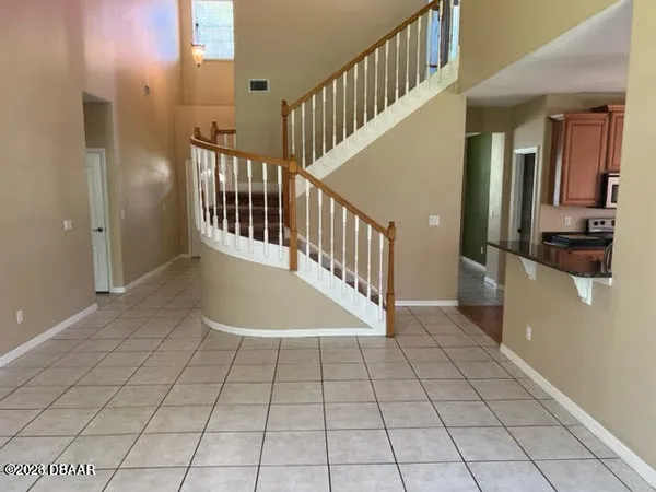 a view of a hallway with entryway and chandelier