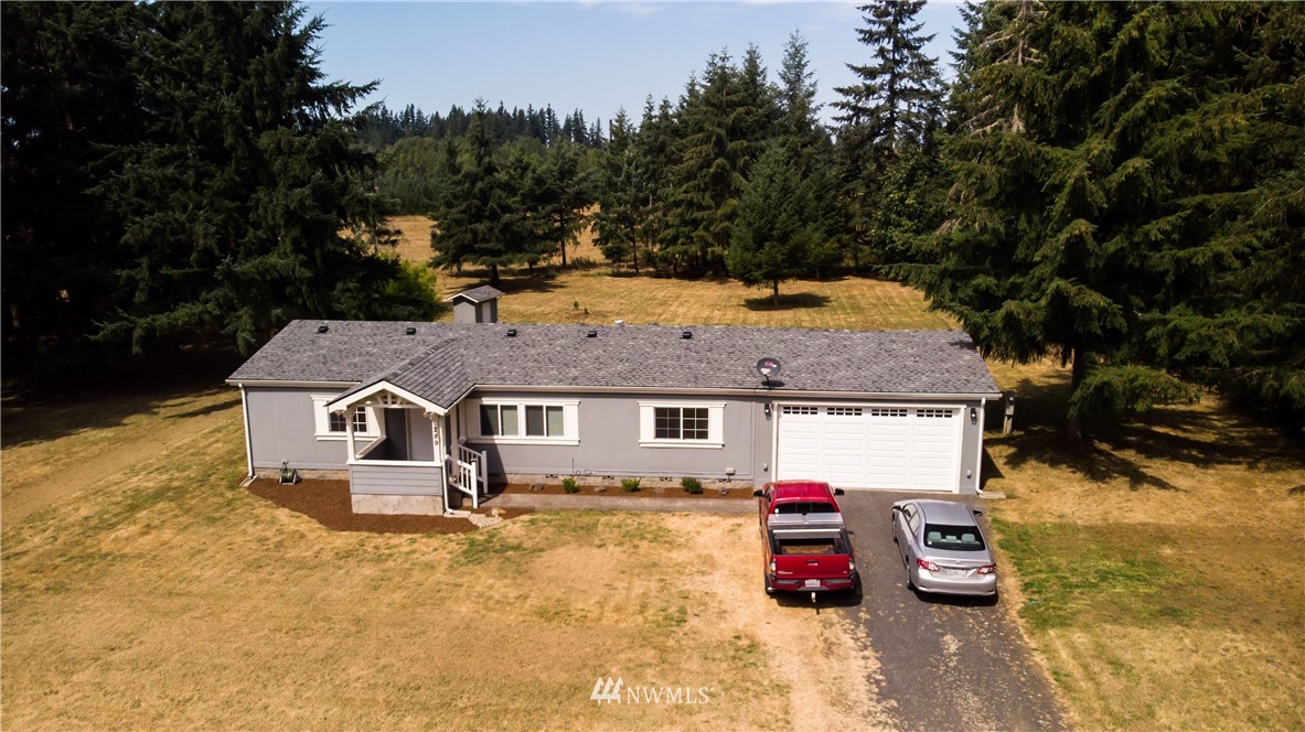 289 Antrim Road Winlock, WA 98596 - Photo 1 of 30 an aerial view of a house with swimming pool and sitting area