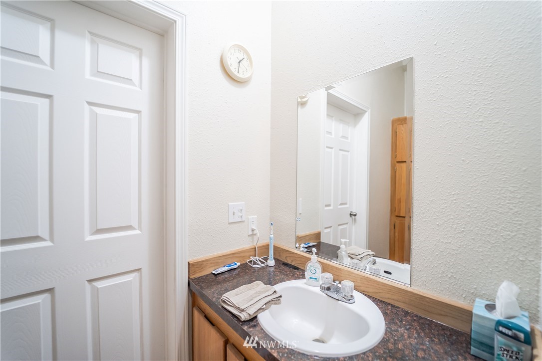 289 Antrim Road Winlock, WA 98596 - Photo 15 of 30 a bathroom with a sink and a mirror