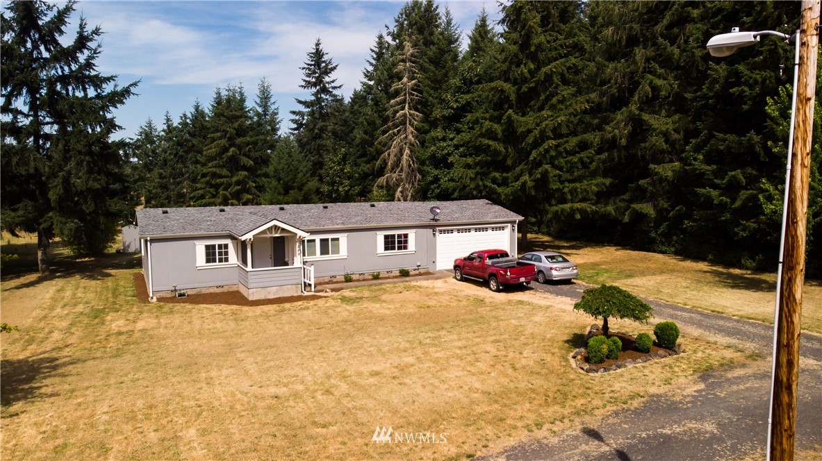 289 Antrim Road Winlock, WA 98596 - Photo 4 of 30 a view of a house with a yard covered in snow
