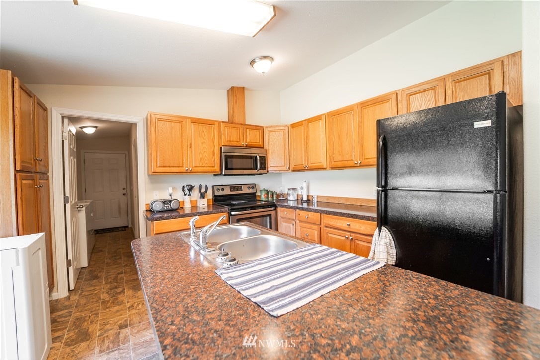 289 Antrim Road Winlock, WA 98596 - Photo 9 of 30 a kitchen with stainless steel appliances granite countertop a refrigerator a stove top oven and a refrigerator