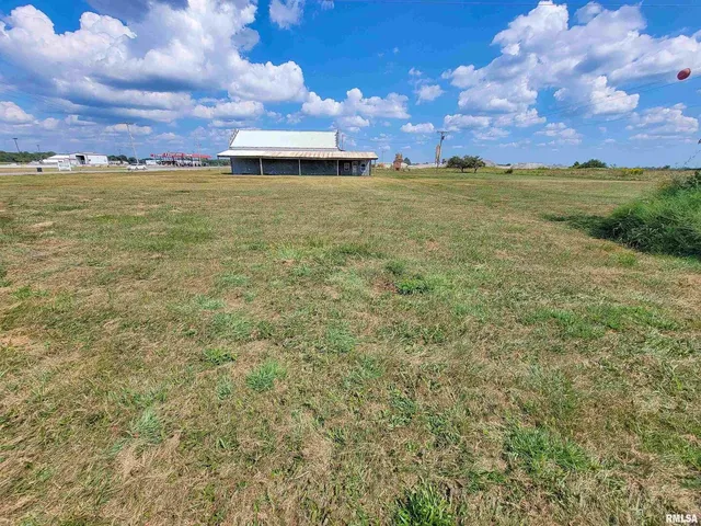 a view of a swimming pool and a yard