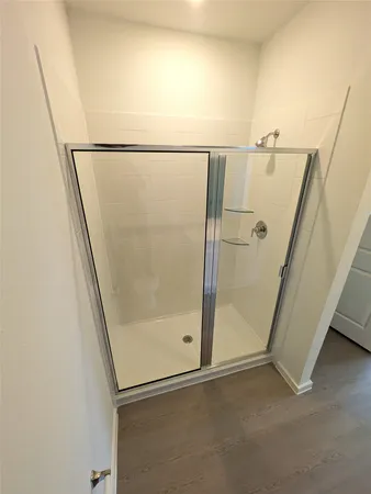 a bathroom with a glass door shower