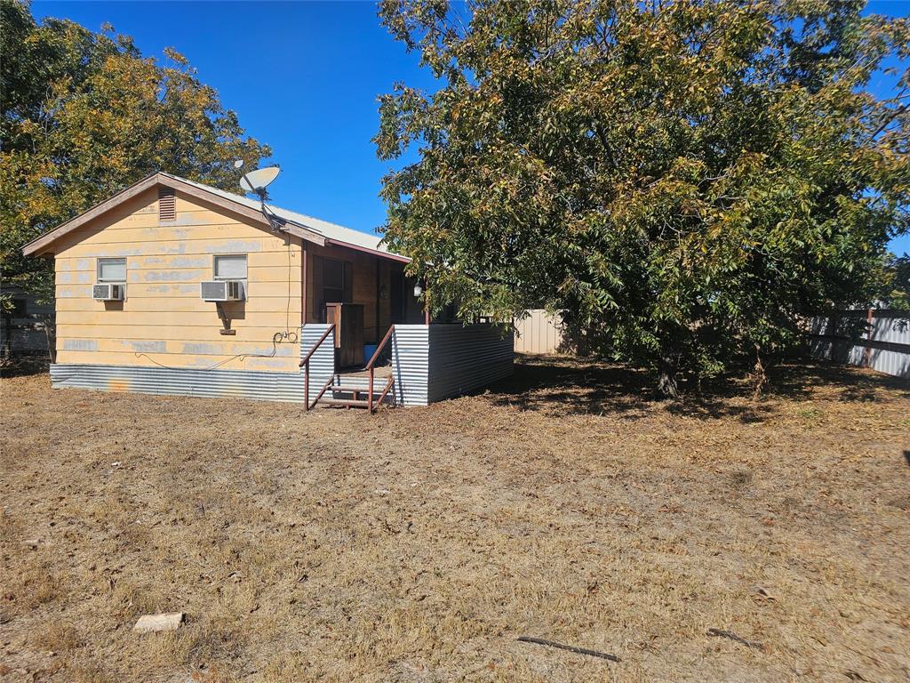 1008 Sixth Street Bangs, TX 76823 - Photo 13 of 24 a view of a house with a yard