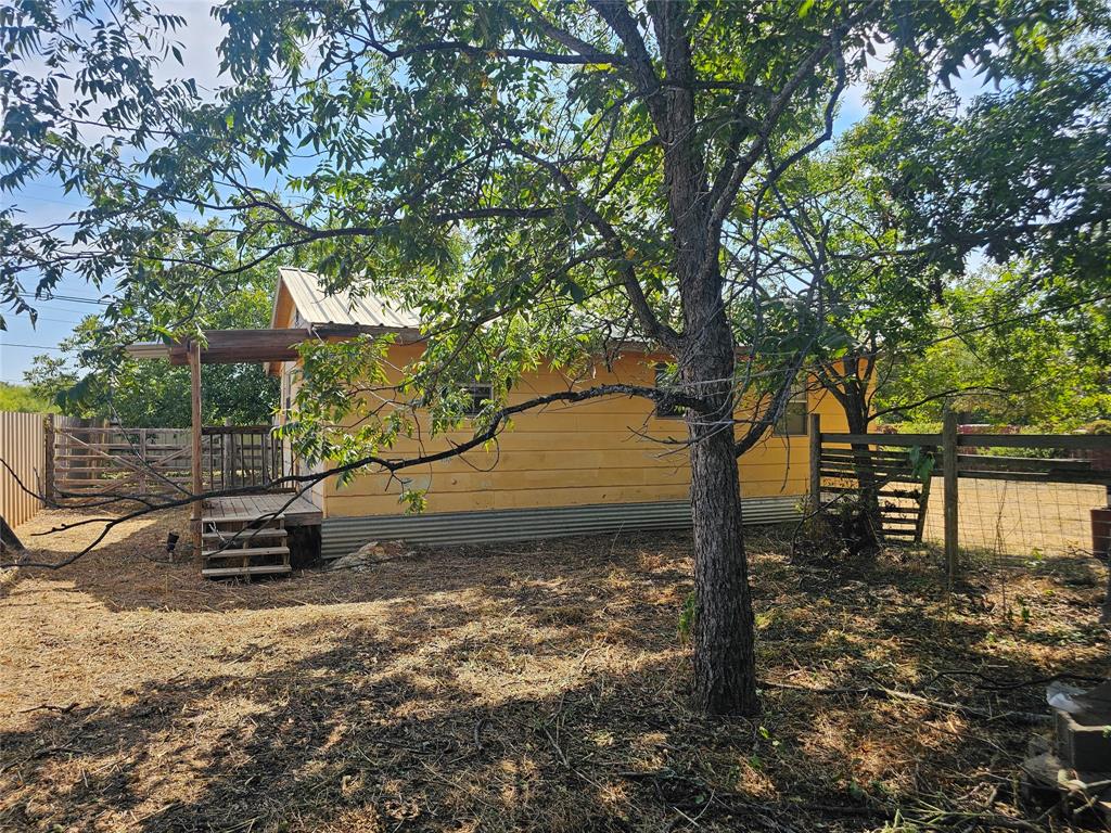 1008 Sixth Street Bangs, TX 76823 - Photo 15 of 24 a backyard of a house with lots of green space