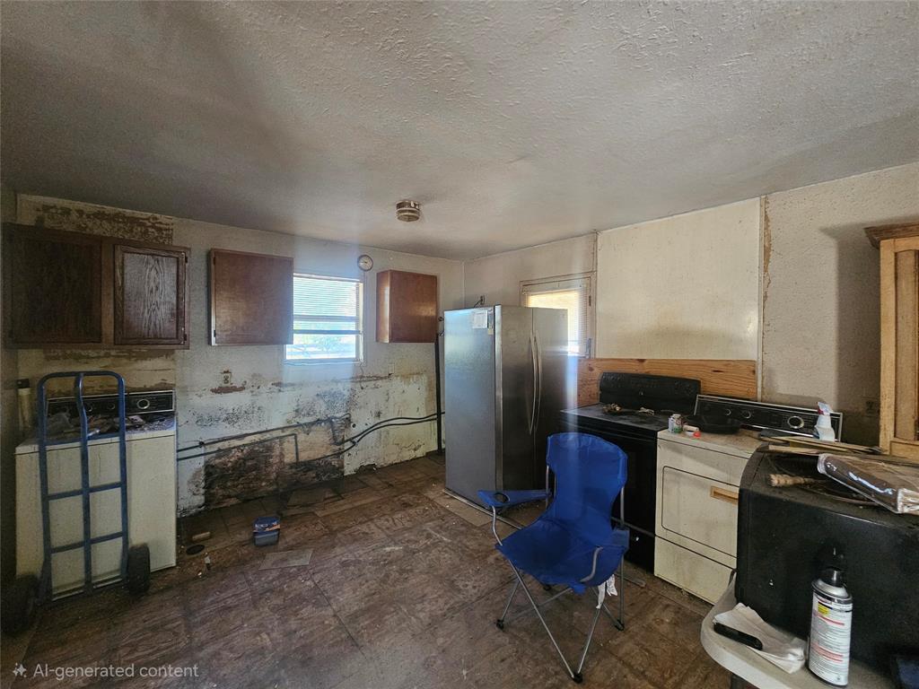 1008 Sixth Street Bangs, TX 76823 - Photo 3 of 24 a kitchen with stainless steel appliances kitchen island granite countertop a refrigerator stove and sink