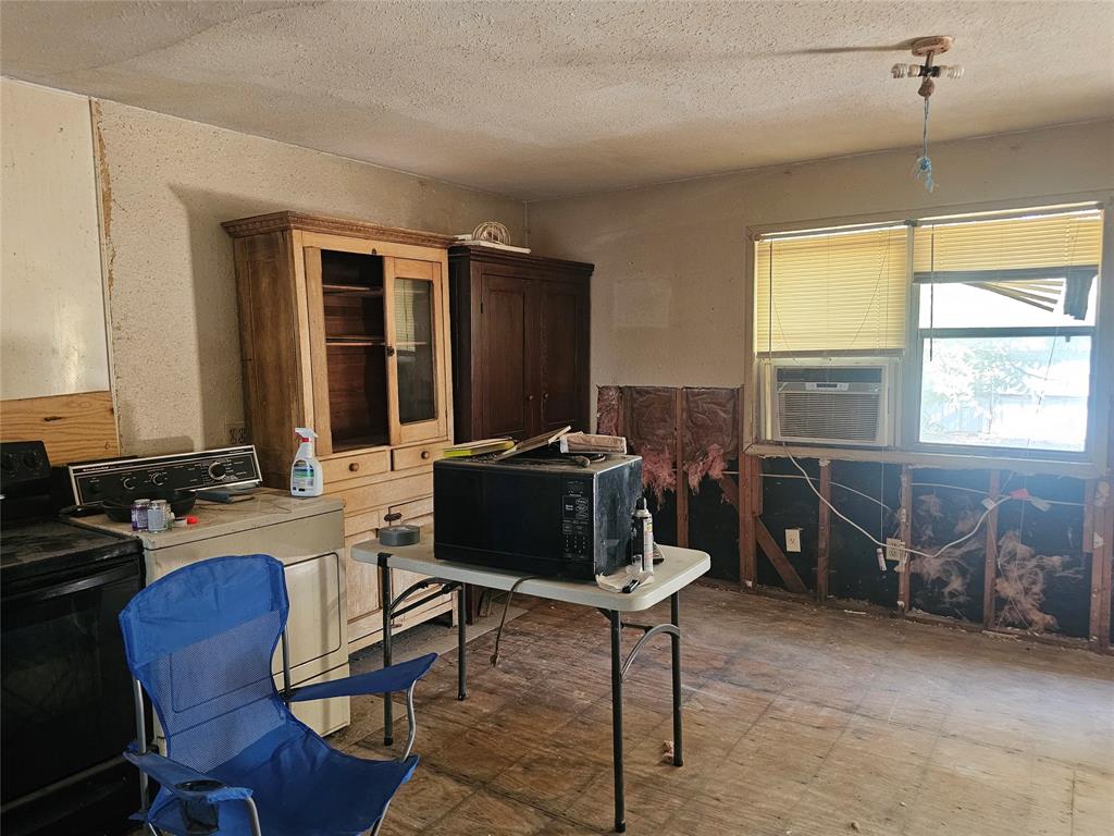 1008 Sixth Street Bangs, TX 76823 - Photo 5 of 24 a living room with furniture a window and a flat screen tv