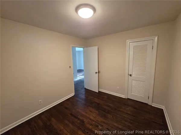 an empty room with wooden floor
