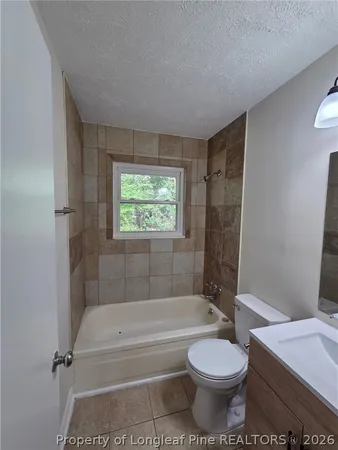 a bathroom with a toilet and a bath tub